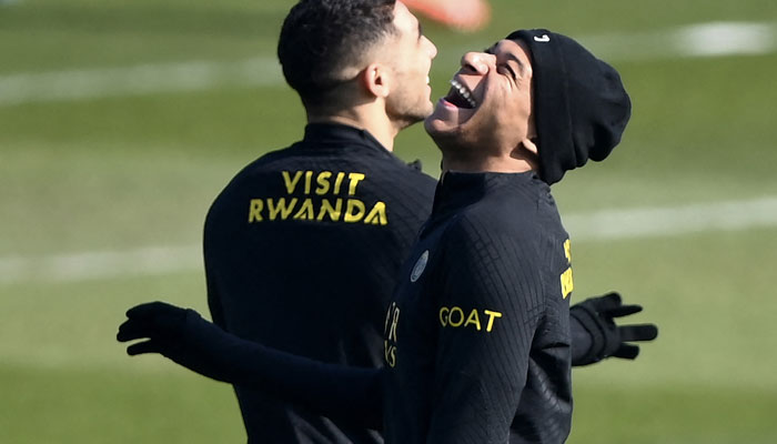 Paris Saint-Germains French forward Kylian Mbappe (R) jokes during a training session at clubs training ground in Saint-Germain-en-Laye, west of Paris on March 3, 2023, on the eve of the L1 football match against Nantes. AFP