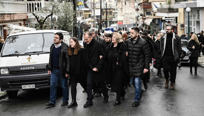 Mourners take part in the funeral procession of Ifigenia Mitska, 23 years-old, in Giannitsa, northern Greece, on March 4, 2023. — AFP
