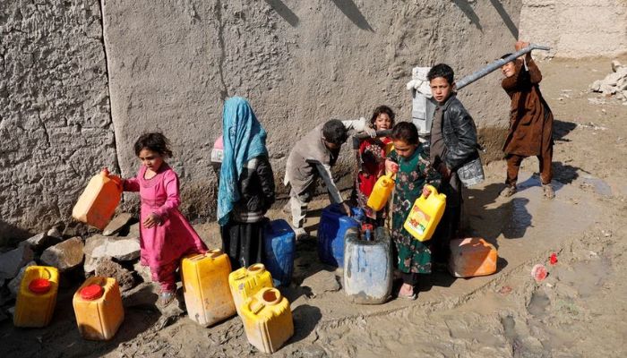 Internally displaced Afghans collect water from a public water pump next to their tents at a refugee camp, during the spread of coronavirus disease (COVID-19), in Kabul, Afghanistan March 28, 2020.— Reuters