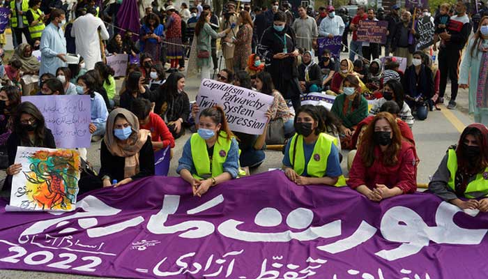 Aurat March protesters hold placards as they gather to mark the International Womens Day in Islamabad on March 8, 2022. — AFP