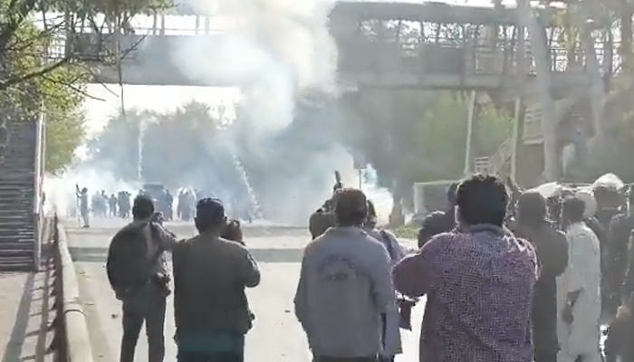 Lahore police fire tear gas at PTI workers in Lahore, on March 8, 2023, in this still taken from a video. — Twitter/@PTIOfficial