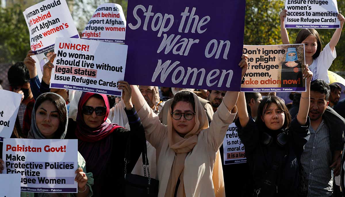 Afghan women refugees carry signs, as they participate in Aurat March in Islamabad. — Reuters