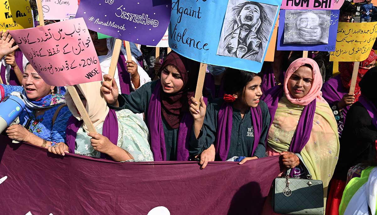 Participants march to mark International Womens Day in Lahore. — AFP