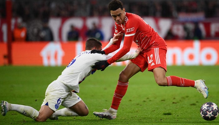 Bayern Munichs German midfielder Jamal Musiala (R) and Paris Saint-Germains Italian midfielder Marco Verratti vie for the ball during the UEFA Champions League round of 16, 2nd-leg football match FC Bayern Munich v Paris Saint-Germain FC in Munich, southern Germany, on March 8, 2023.AFP