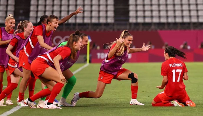 Canadas players celebrate after winning the womens semifinal soccer match against the United States on Monday. Reuters