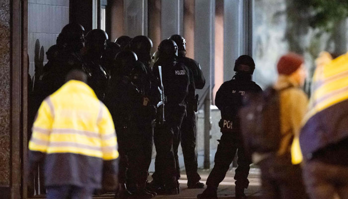 Police stand outside a Jehovah´s Witnesses church where several people have been killed in a shooting in Hamburg, northern Germany, on late March 9, 2023. AFP