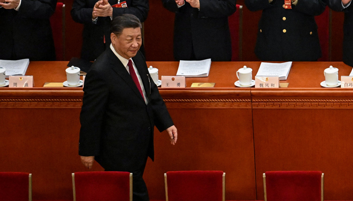 Chinas President Xi Jinping is applauded as he arrives for the opening session of the National Peoples Congress (NPC) at the Great Hall of the People in Beijing on March 5, 2023. — AFP