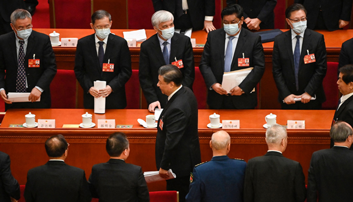 Xi Jinping (bottom) leaves after the second plenary session of the National Peoples Congress (NPC) at the Great Hall of the People in Beijing on March 7, 2023. — AFP