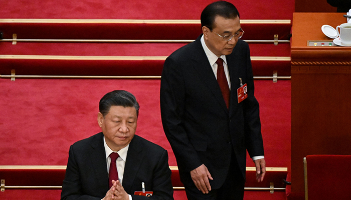 Chinas Premier Li Keqiang (R) walks past Xi Jinping (C) after delivering his work report during the opening session of the National Peoples Congress (NPC) at the Great Hall of the People in Beijing on March 5, 2023. — AFP