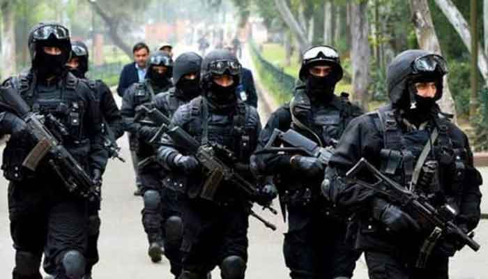 The picture shows law enforcement agency personnel. — APP/File