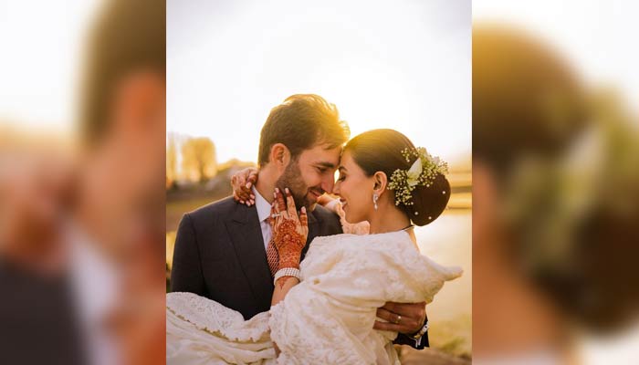 Pakistani actor Ushna Shah (right) and her husband, Hamza Amin, can be seen embracing each other during their valima ceremony. — Instagram/ushnashah