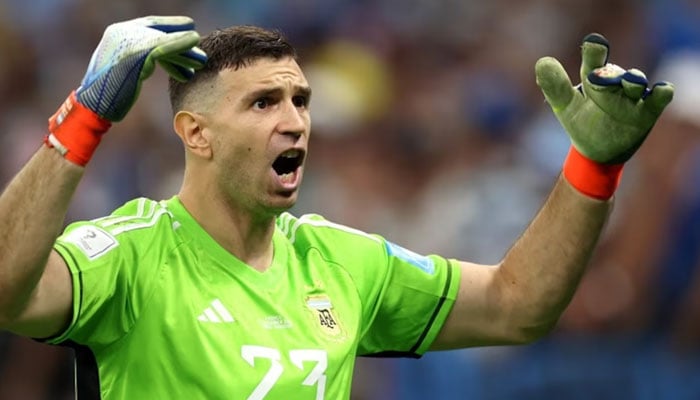 The picture shows Argentina goalkeeper Emiliano Dibu Martinez wearing gloves in FIFA World Cup final in Qatar which were auctioned on Friday. Twitter