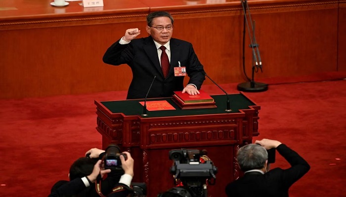 Chinas newly-elected Premier Li Qiang takes an oath after being elected during the fourth plenary session of the National Peoples Congress (NPC) at the Great Hall of the People in Beijing, China on March 11, 2023. — Reuters
