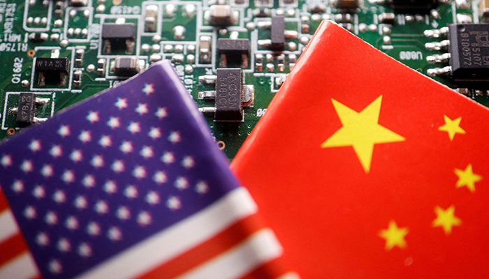 Flags of China and US are displayed on a printed circuit board with semiconductor chips, in this illustration picture taken February 17, 2023. — Reuters