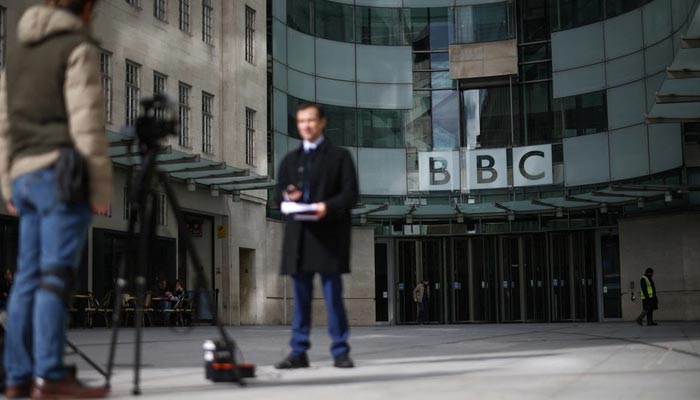 A BBC correspondent reports to a camera outside the BBC headquarters in central London, Britain, March 11, 2023. — Reuters