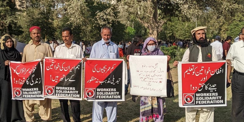 Several people associated with Workers Solidarity Federation show placards highlighting some of the grave concerns of the women at Burns Garden on March 12, 2023. — Photo by author