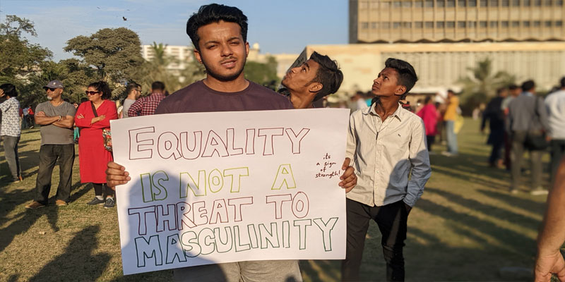 A boy holding placard during this years Aurat March which was held at Burns Garden on March 12, 2023. — Photo by author