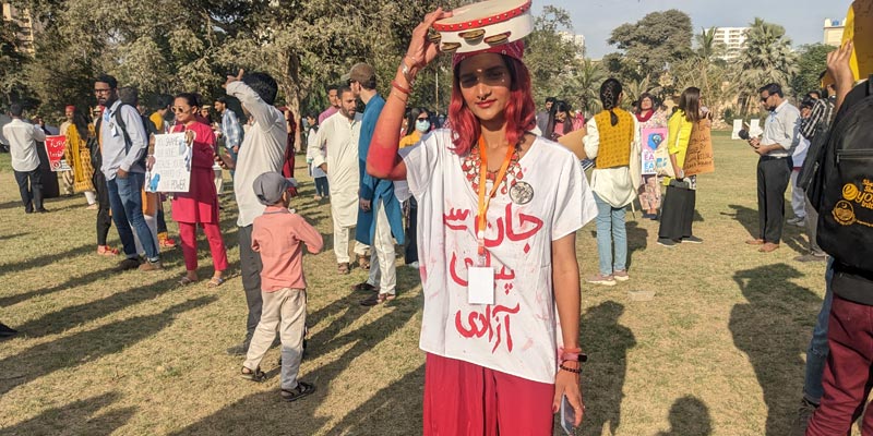 A young girl can be seen posing for the camera with a slogan printed on her shirt at Burns Garden where Aurat March was held on March 12, 2023. — Photo by author