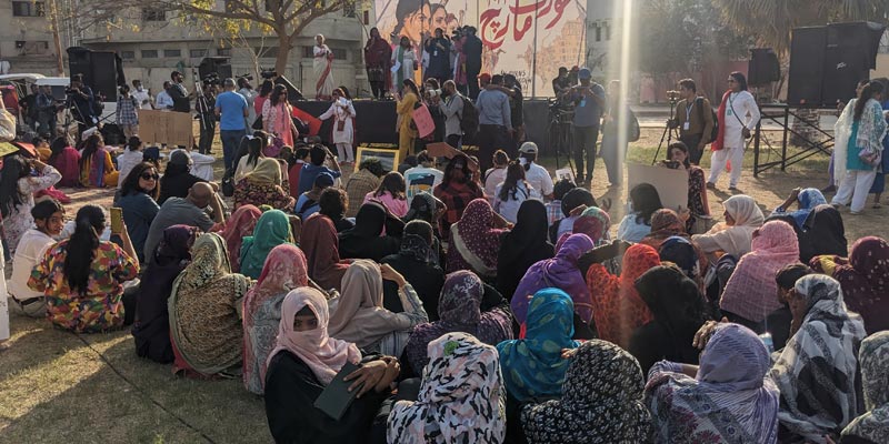 Scores of women can be sitting on the ground where this years Aurat March was organised on March 12, 2023. — Photo by author