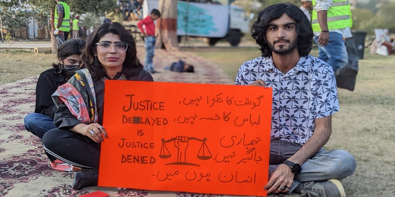 A girl and a boy showing a placard during Aurat March which was held at Burns Garden on March 12, 2023. — Photo by author