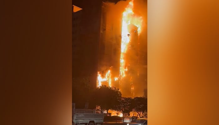 Fire can be seen engulfing the high-rise in Karachi on March 12, 2023, in this still taken from a video. — Photo by author