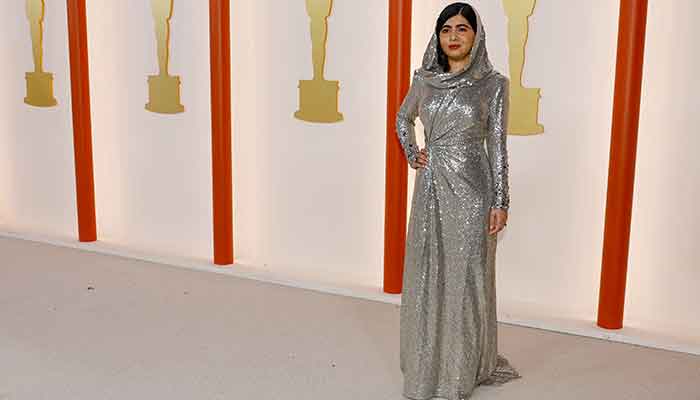 Malala Yousafzai poses on the champagne-coloured red carpet during the Oscars arrivals at the 95th Academy Awards in Hollywood, Los Angeles, California, US, March 12, 2023. — Reuters