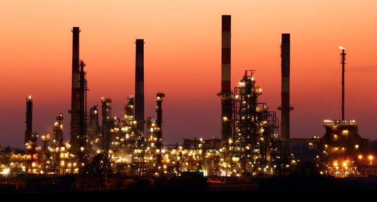 The chimneys of the Total Grandpuits oil refinery are seen just after sunset, southeast of Paris, France, March 1, 2021. — Reuters/File