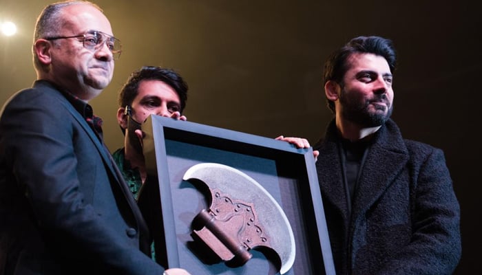 Fawad Khan (left), the lead actor of Pakistans highest-grossing movie The Legend of Maula Jatt while presenting the Gandasa to the buyer in the Canada auction. — Provided by the author