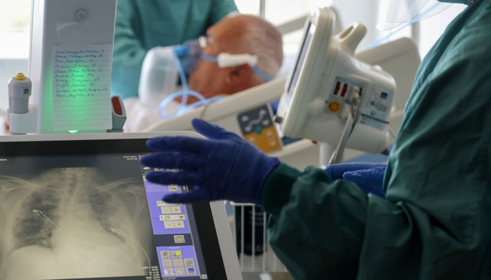 Hospital staff do an x-ray of the lung of a patient suffering from respiratory complications in Barcelona, Spain. — Reuters/File