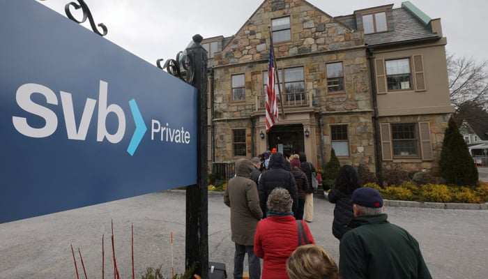 Customers wait in line outside a branch of the Silicon Valley Bank in Wellesley, Massachusetts, US. — Reuters.File