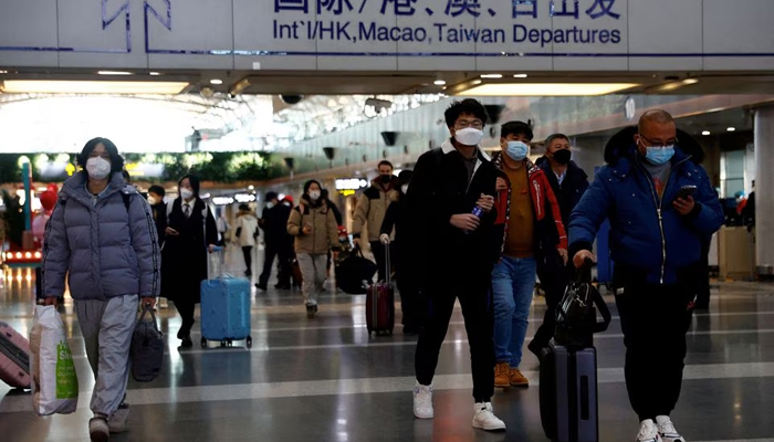 Travellers walk with their luggage at Beijing Capital International Airport, amid the coronavirus disease (COVID-19) outbreak in Beijing, China. — Reuters/File