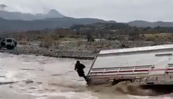 A screengrab was taken from the video in which a Pakistani living abroad can be seen in the air while jumping from the overturned truck. — Saudi Gazette