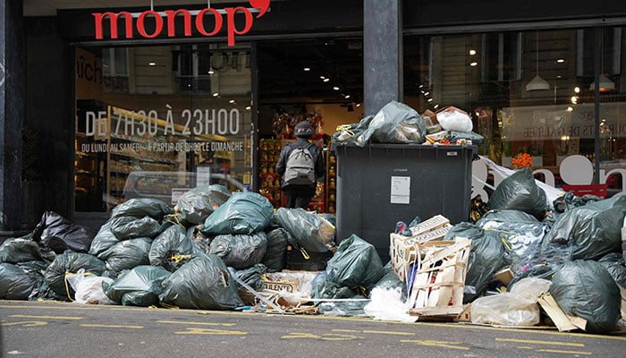 Piles of garbage accumulated outside a supermarket in Paris on March 14, 2023, since collectors went on strike against the French government´s proposed pensions reform.— AFP