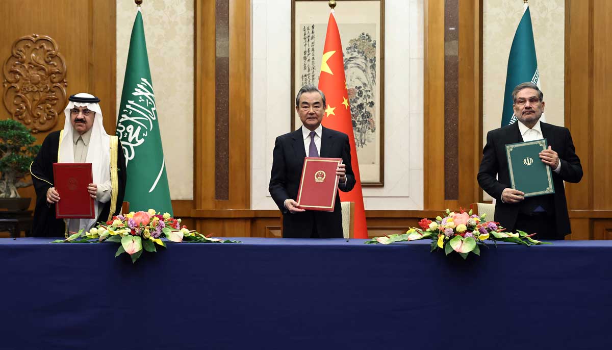 Saudi Arabias Musaad bin Mohammed Al Aiban (left), China’s top diplomat Wang Yi and Irans Ali Shamkhani in Beijing on Friday. — Reuters