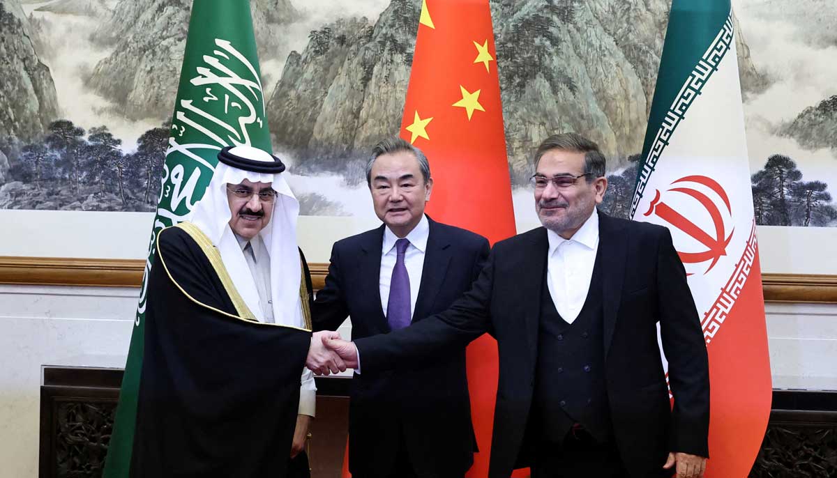 Saudi Arabias Musaad bin Mohammed Al Aiban (left), China’s top diplomat Wang Yi and Irans Ali Shamkhani stand together in Beijing on Friday. — Reuters