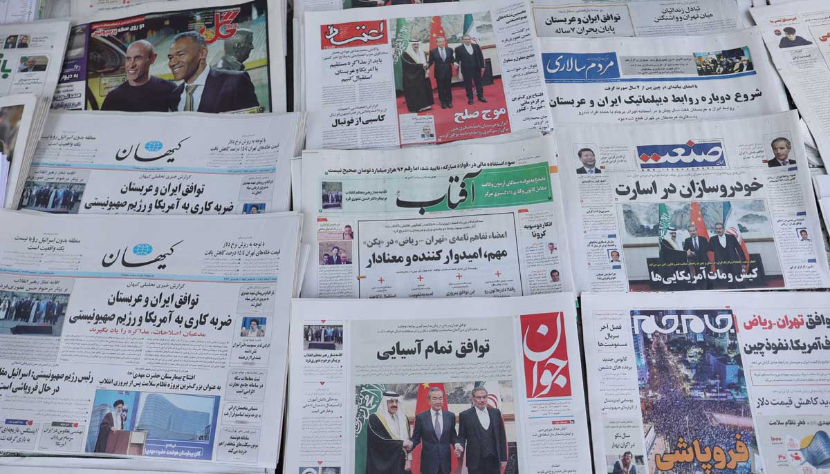 Newspapers with a cover picture of the Iranian Rear Admiral Ali Shamkhani, the secretary of the Supreme National Security Council and Saudi Minister of State and National Security Adviser Musaed bin Mohammed Al-Aiban, is seen in Tehran, Iran March 11, 2023. — Reuters