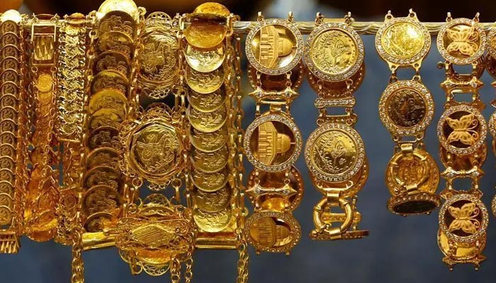 A dealer displays gold bracelets showing the Dome of the Rock mosque at his jewellery shop in Amman, Jordan, December 12, 2017. — Reuters