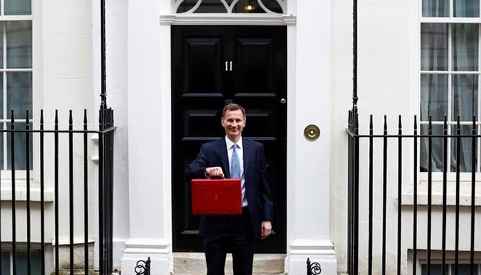 Britains Chancellor of the Exchequer Jeremy Hunt holds the budget box on Downing Street in London, Britain March 15, 2023. — Reuters