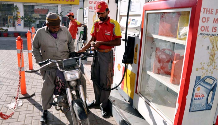 Fuel station worker filling petrol in a motorcycle at a petrol pump in Hyderabad on Sunday, January 29, 2023. — PPI