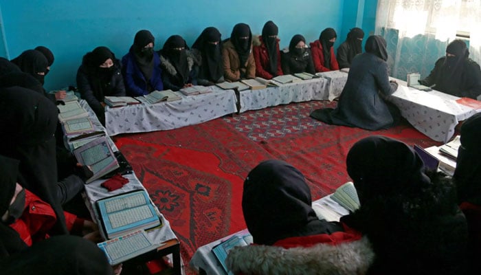 Afghan girls learn the holy Koran at a madrassa on the outskirts of Kabul. AFP