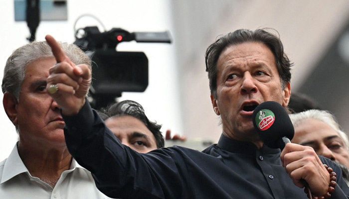 Former prime minister Imran Khan (right) addresses his supporters during an anti-government march towards Islamabad in Gujranwala on November 1, 2022. — AFP