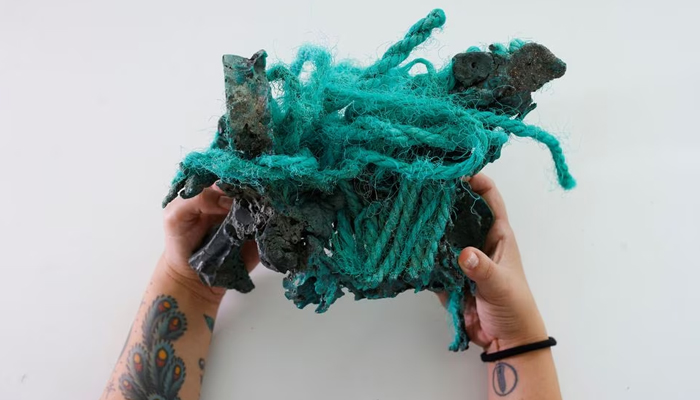 Researcher Fernanda Avelar Santos holds plastic rocks found on Trindade Island in the state of Espirito Santo, at the laboratory of the Federal University of Parana, in Curitiba state of Parana, Brazil March 7, 2023. — Reuters