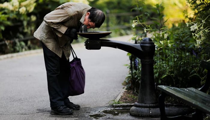 A man drinks from a water fountain on a hot summer day in Central Park, Manhattan, New York, US. — Reuters/File