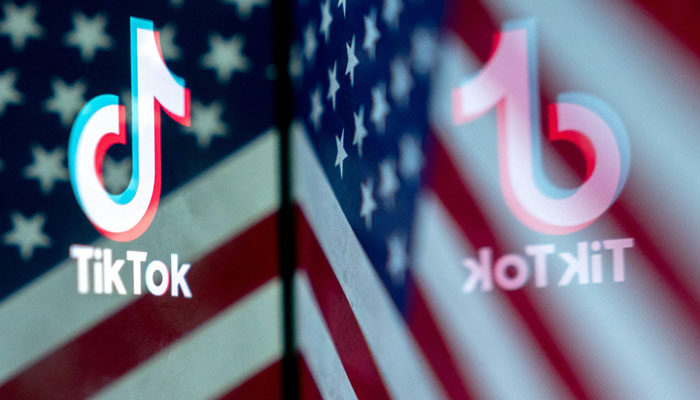 This photo illustration shows the TikTok logo reflected in an image of the US flag, in Washington, DC, on March 16, 2023. —AFP