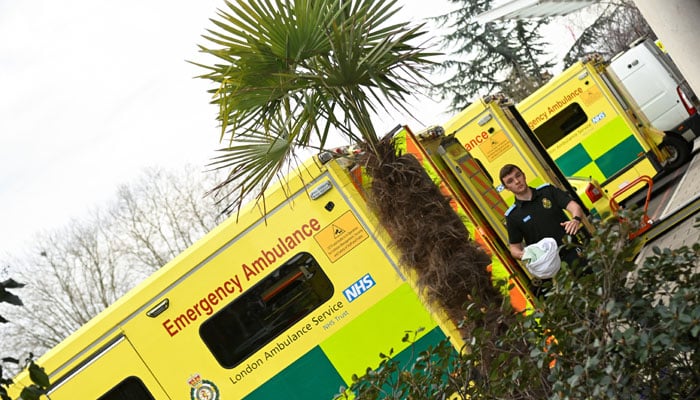 An ambulance staff walks next to parked ambulances at St Georges hospital during British Prime Minister Rishi Sunaks visit in London, Britain March 16, 2023. — Reuters