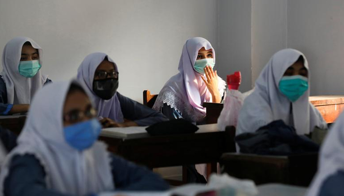 Students wear protective masks while maintaining a safe distance as they attend a class as schools reopen amid the coronavirus disease (COVID-19) pandemic. — Reuters/File