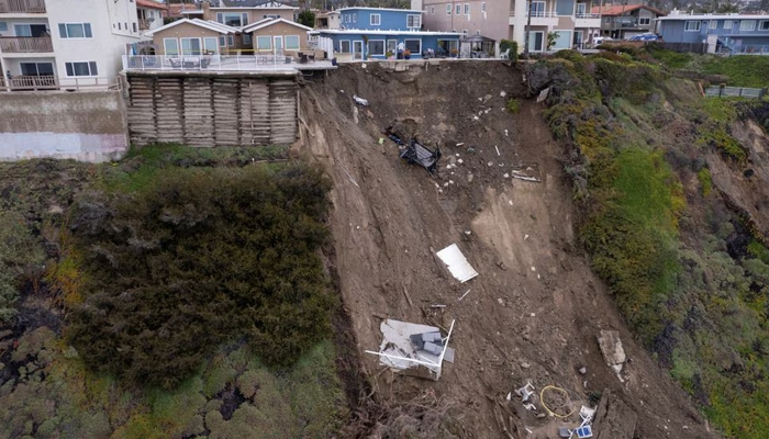 A backyard pool is left hanging on a cliff side after torrential rain brought havoc on the beachfront town of San Clemente, California, US March 16, 2023. — Reuters