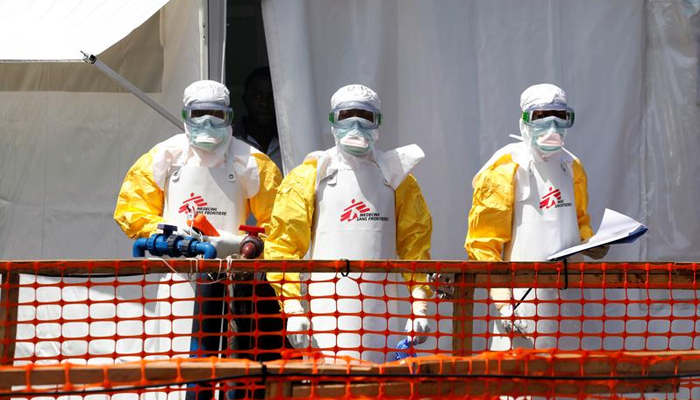 Healthcare workers can be seen standing in protective kits. — Reuters/File