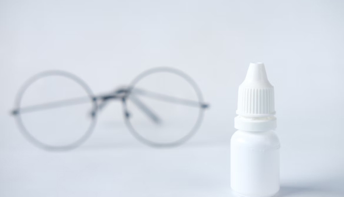 In this representational image, a bottle of eye drops and glasses can be seen. — Unsplash/File