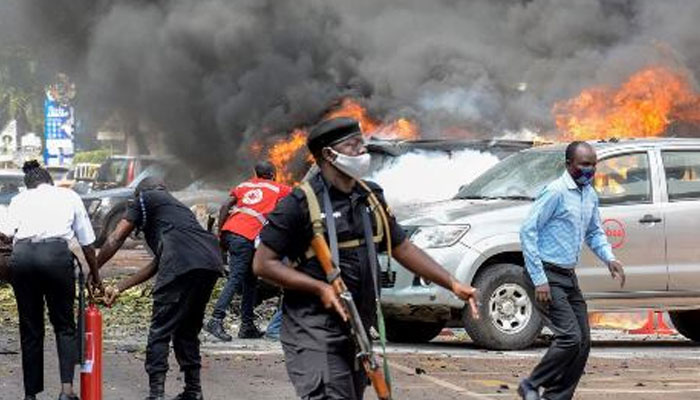 Rescue officials trying to extinguish a fire caused by an explosion near the parliament house in Uganda. — AFP/File